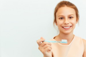 Little girl holding toothbrush.  Happy girl brushing her teeth